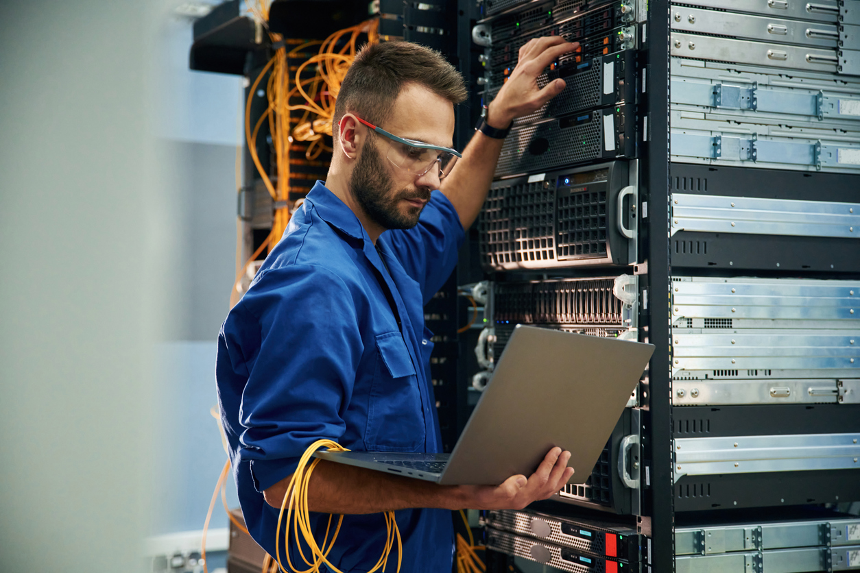 A man working on server cabinets